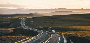 long distance moving truck driving across open road